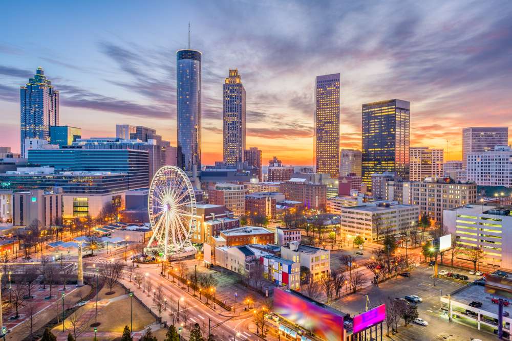Downtown Atlanta at dusk with a sunset in the background.