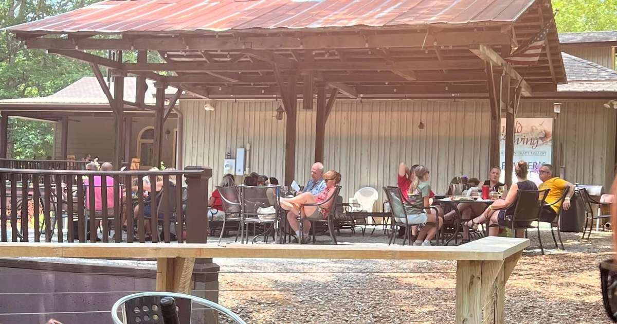 People lounging on a pavilion at Feathers Edge Vineyards