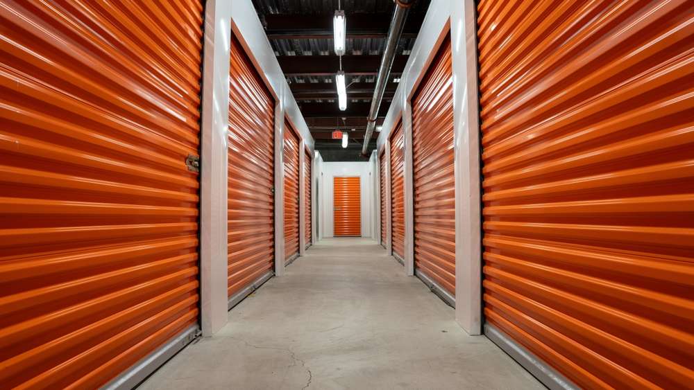 Empty,Hallway,With,Orange,Garage,Doors,Of,A,Self,Storage