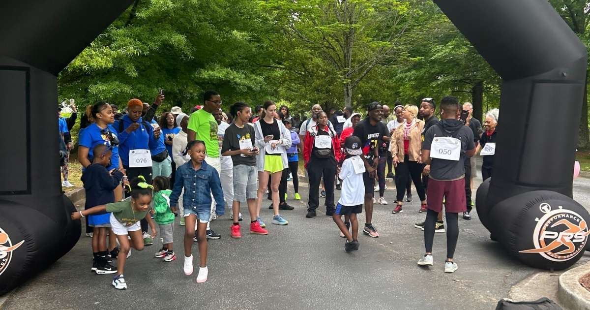 A group of runners gathered at the starting line of a fun run in Clayton County