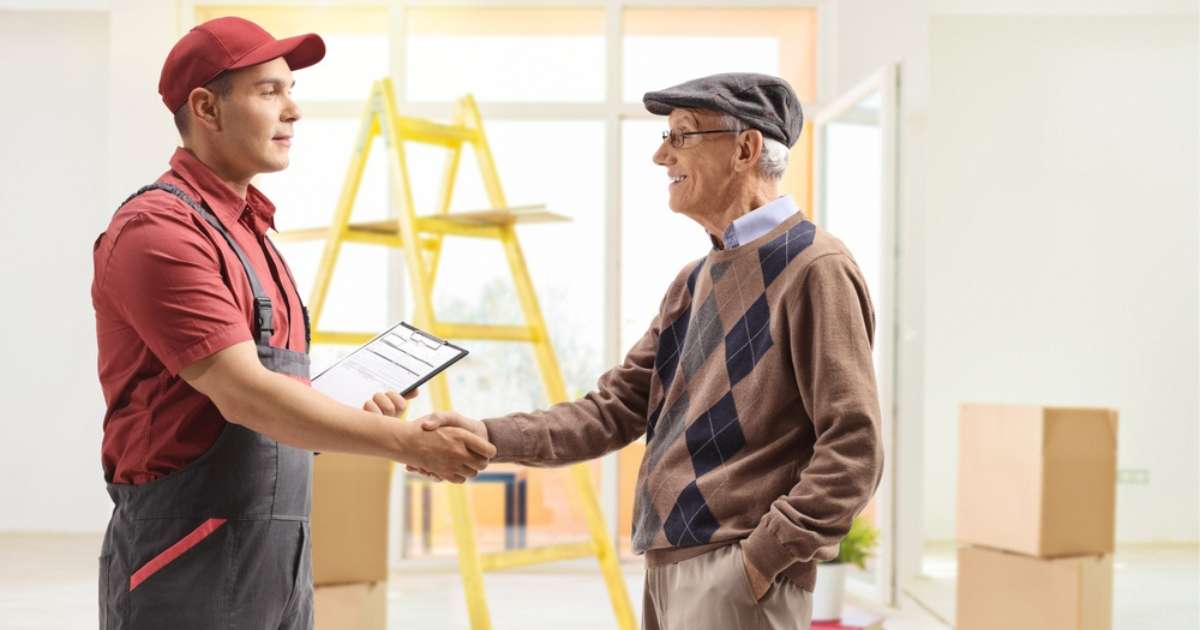 A senior shaking hands with a senior mover Atlanta