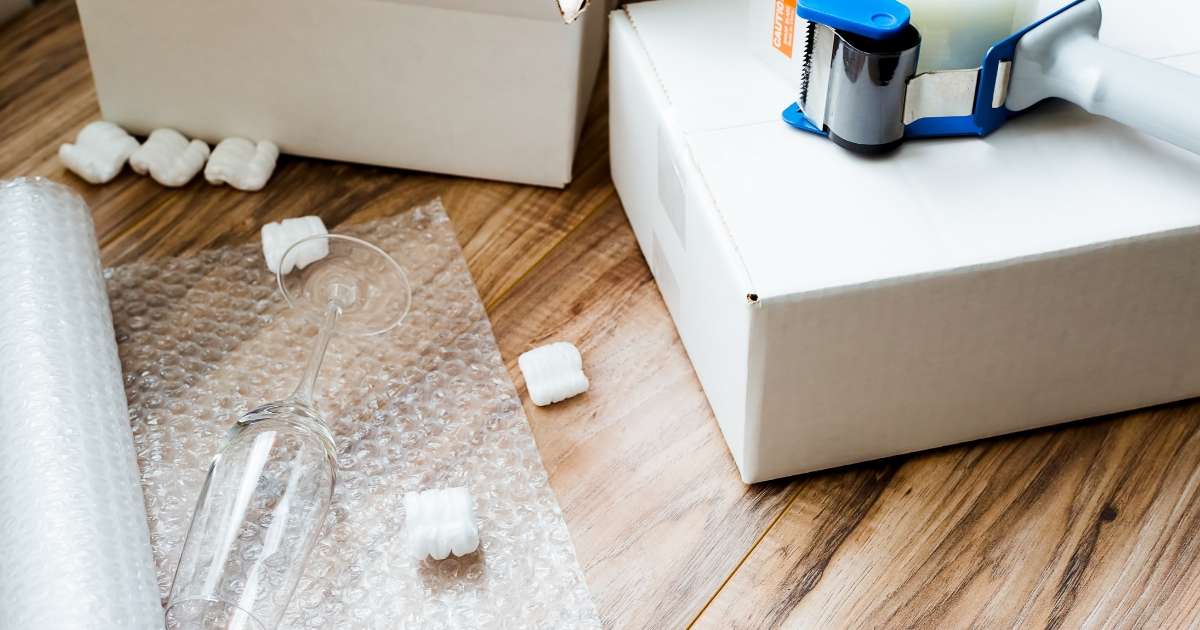 Packing supplies including tape, bubble wrap, and boxes. 