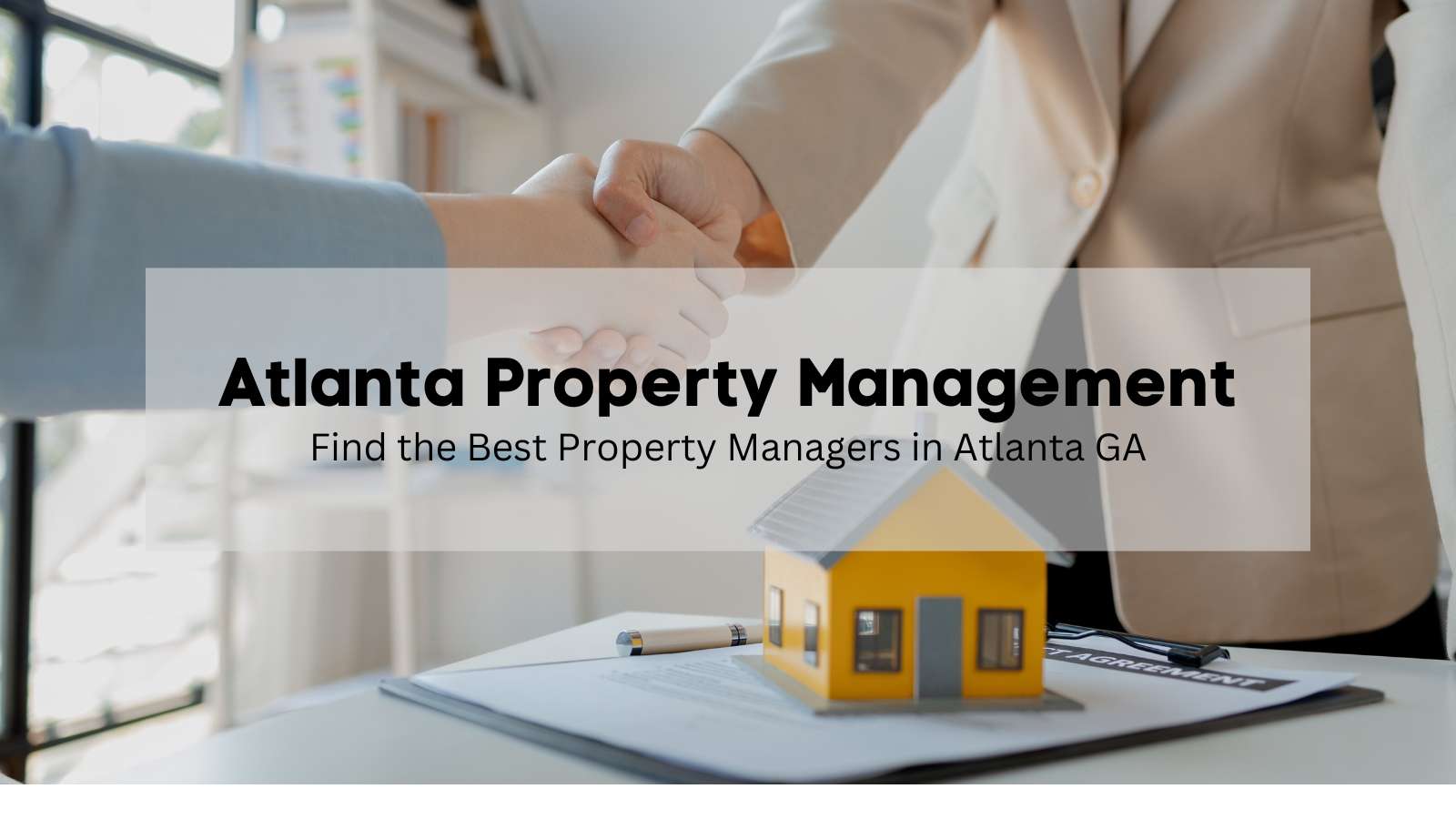 Two people shaking hands in the office of an Atlanta property management company.