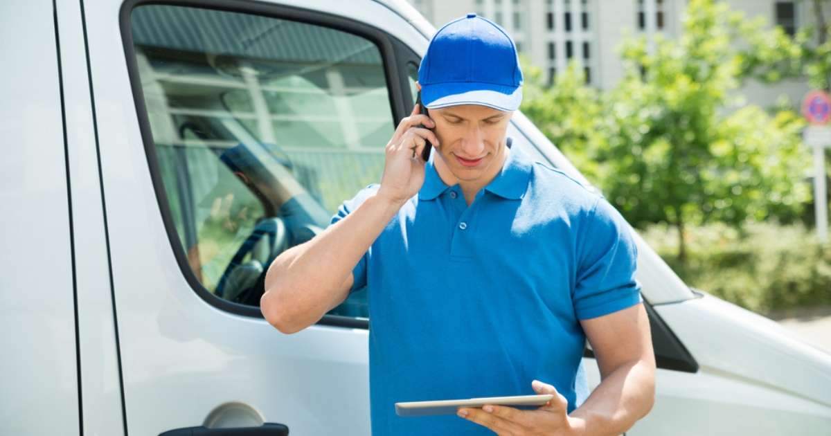 A moving professional from a Newnan moving company making a phone call