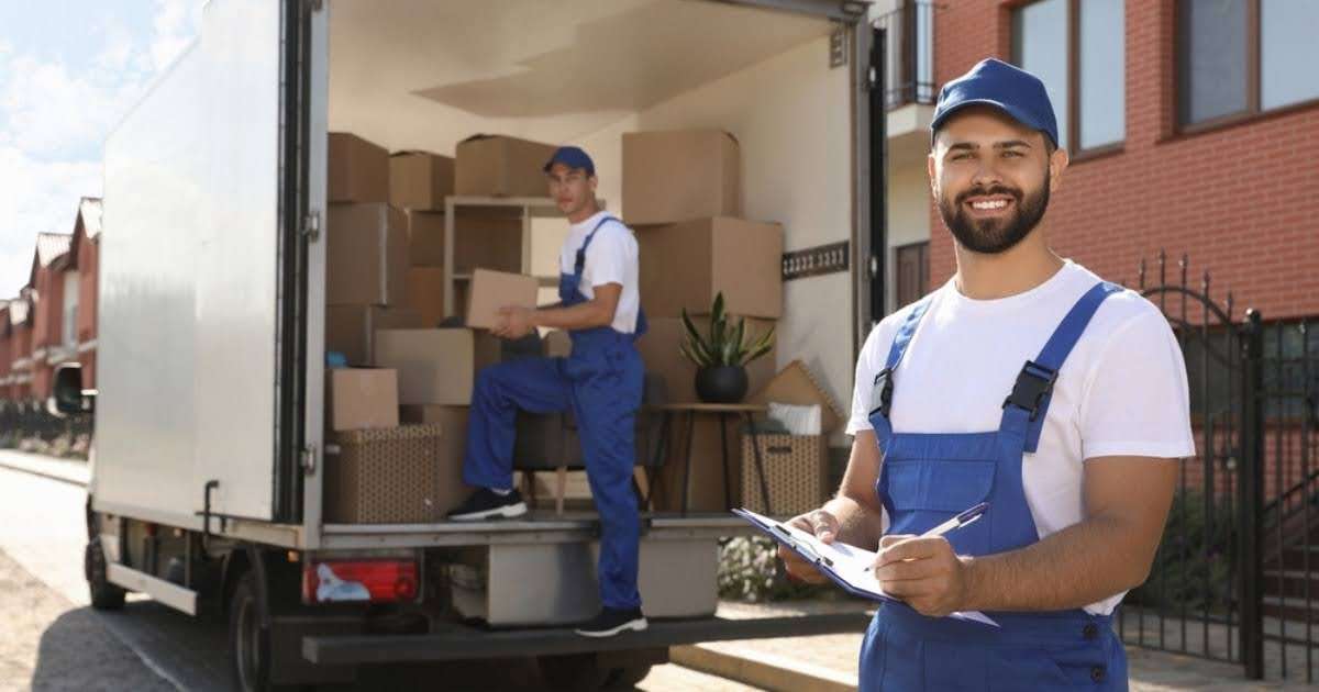 Two professionals from a Bremen moving company standing near a moving truck